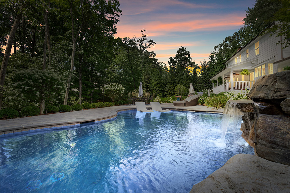 custom backyard pool design at sunset
