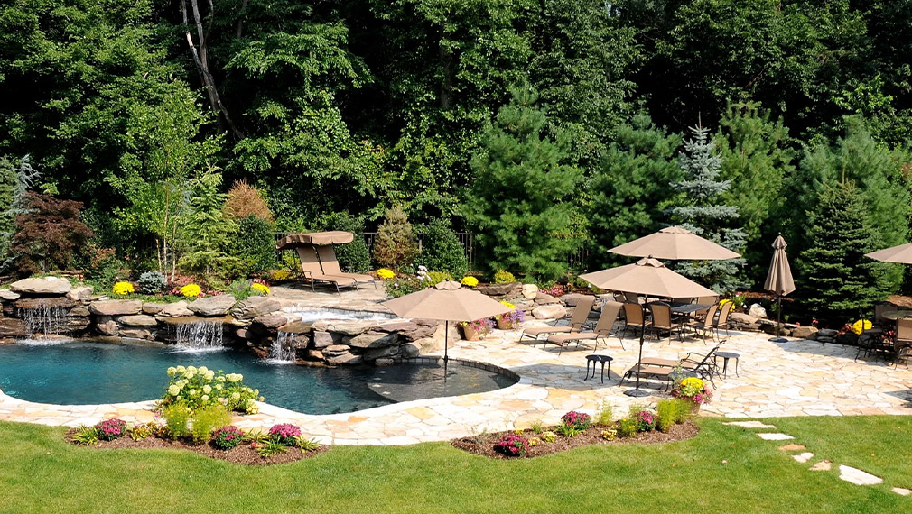 beautiful deck with pool and waterfalls