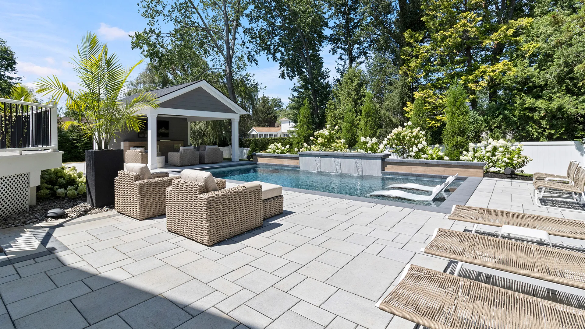 Featured image for “5 Features That Elevate Pool Design: Pool House, Kitchen, Swim-Up Bars, Sunshelves & Fire Pits”
